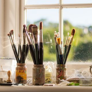 Paint brushes in glass jars