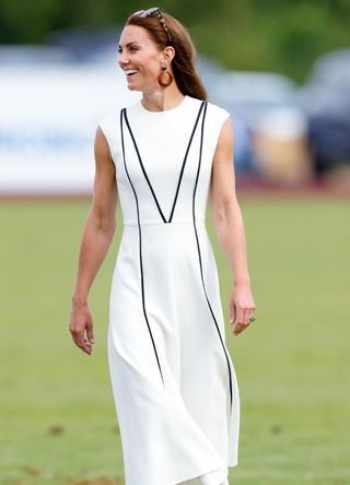Kate Middleton wearing a white summer dress with black piping