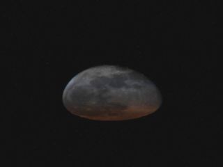 Astronaut Soichi Noguchi shared this view of the squashed moon that he captured from the International Space Station on March 31, 2021.