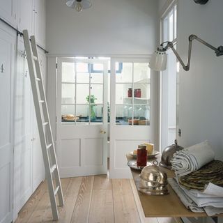 kitchen pantry with wooden flooring and white ladder
