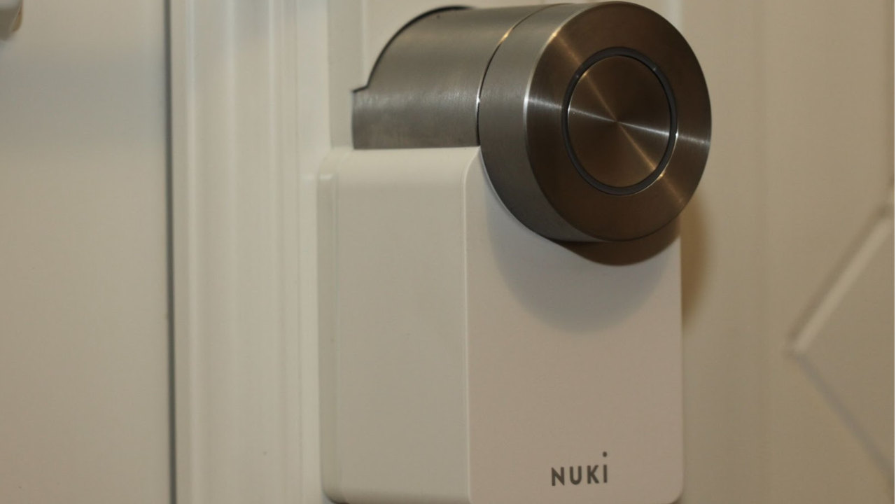 Side view of Ultion Nuki Plus smart lock fitted on a front door