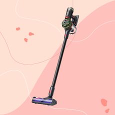 Dyson V8 Cyclone Cordless Vacuum Cleaner on a pink background