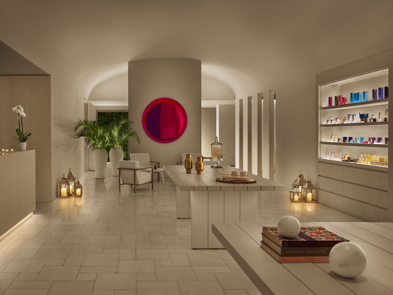 A soothing, cream-tinted spa features colorful fragrance items and reflective accents along with Middle Eastern-inspired decorative touches.