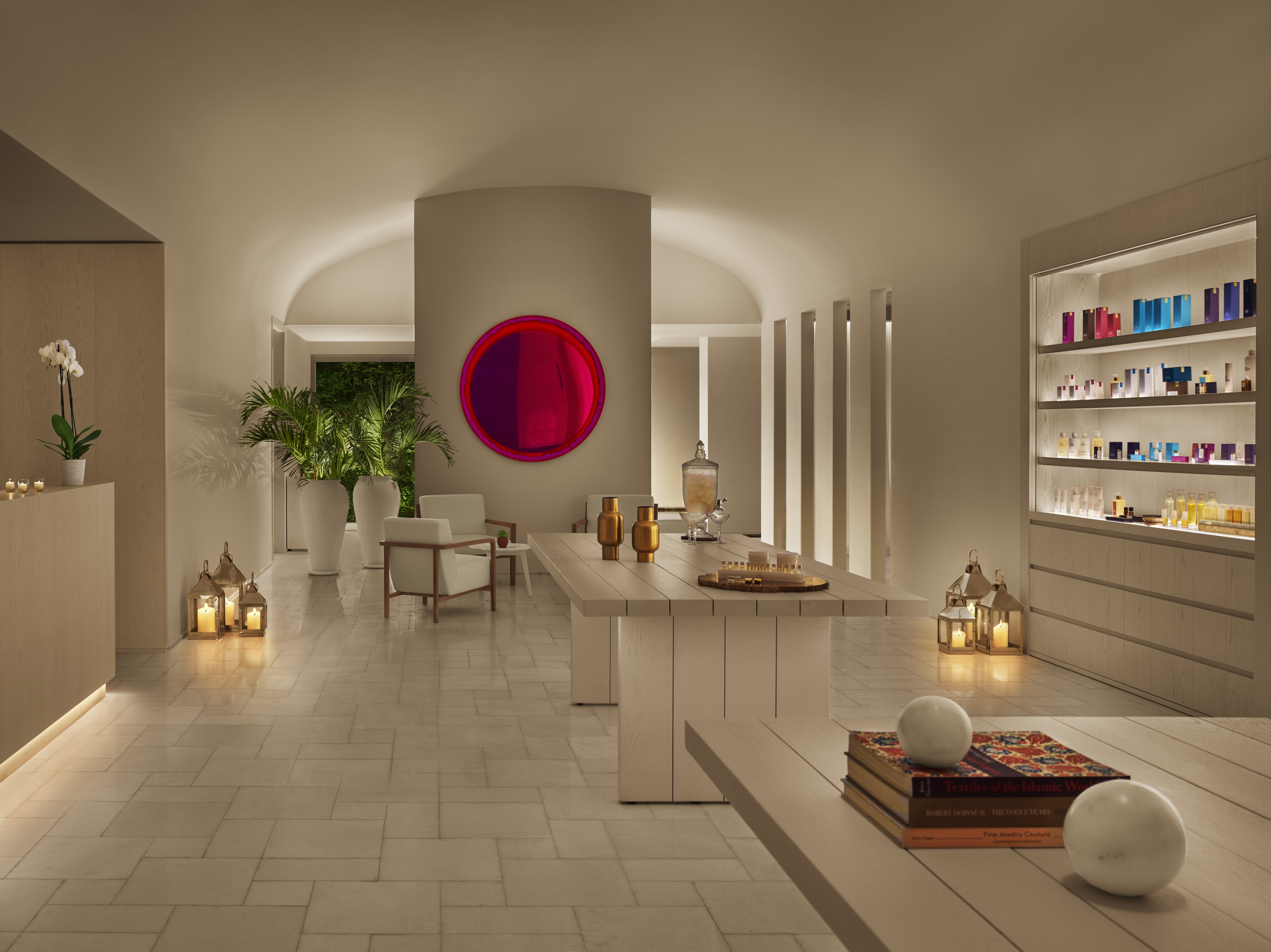 A soothing, cream-tinted spa features colorful fragrance items and reflective accents along with Middle Eastern-inspired decorative touches.