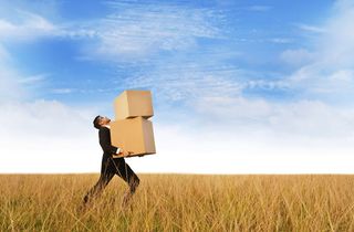 man with boxes in field