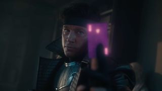 Gambit holding up a charged card