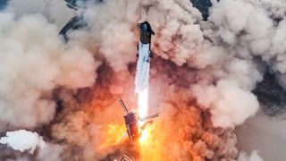 a large white and black rocket lifts off
