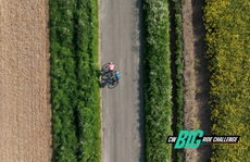 Two riders riding between fields shot from above
