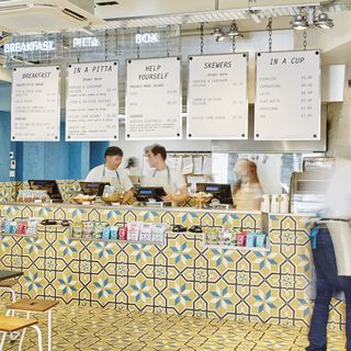 restaurant with mustard tiles and men