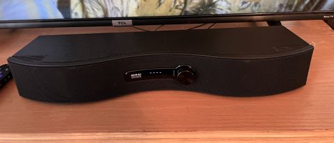 Soundfun Mirai soundbar on table with TV and remote