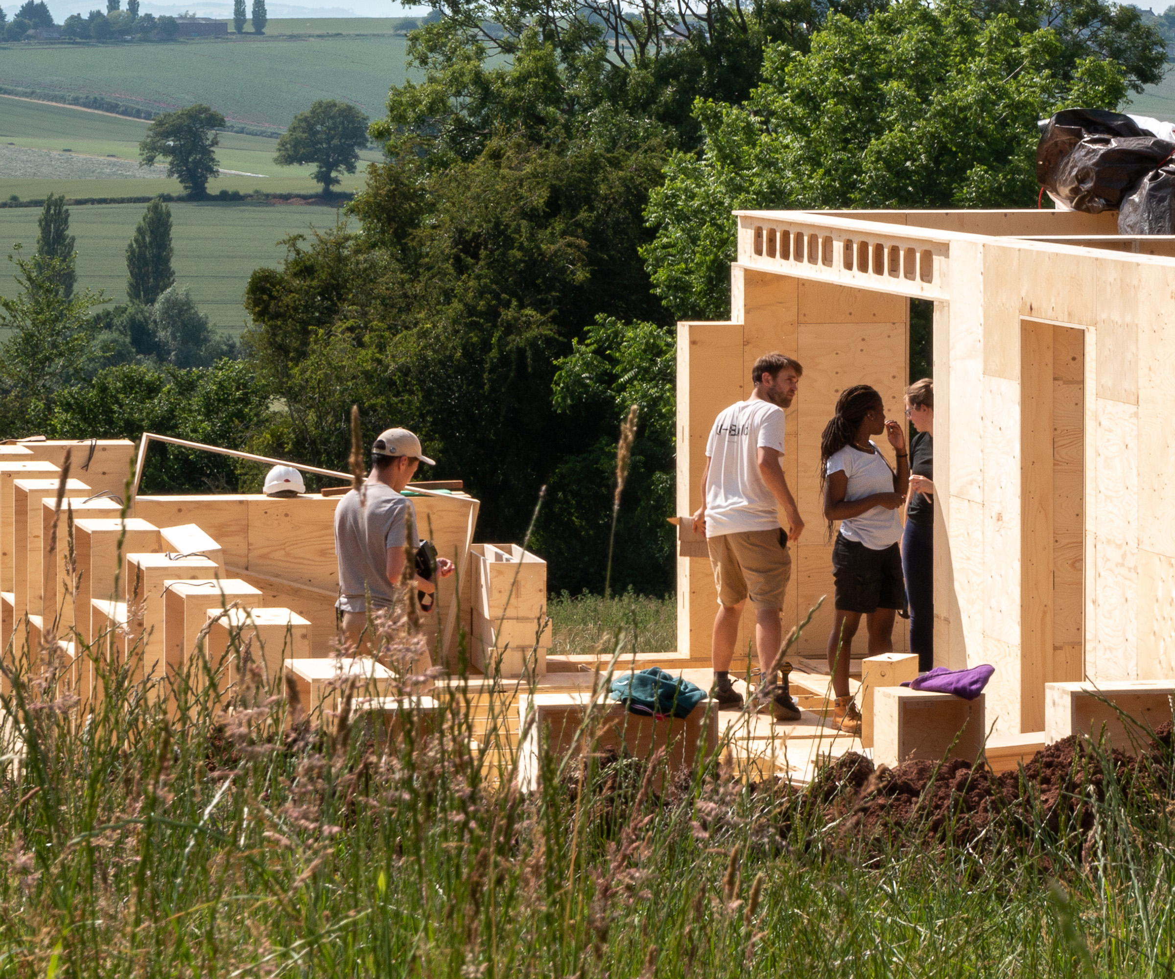 trainee builders working on constructing a self-build home from a sustainable modular timber system