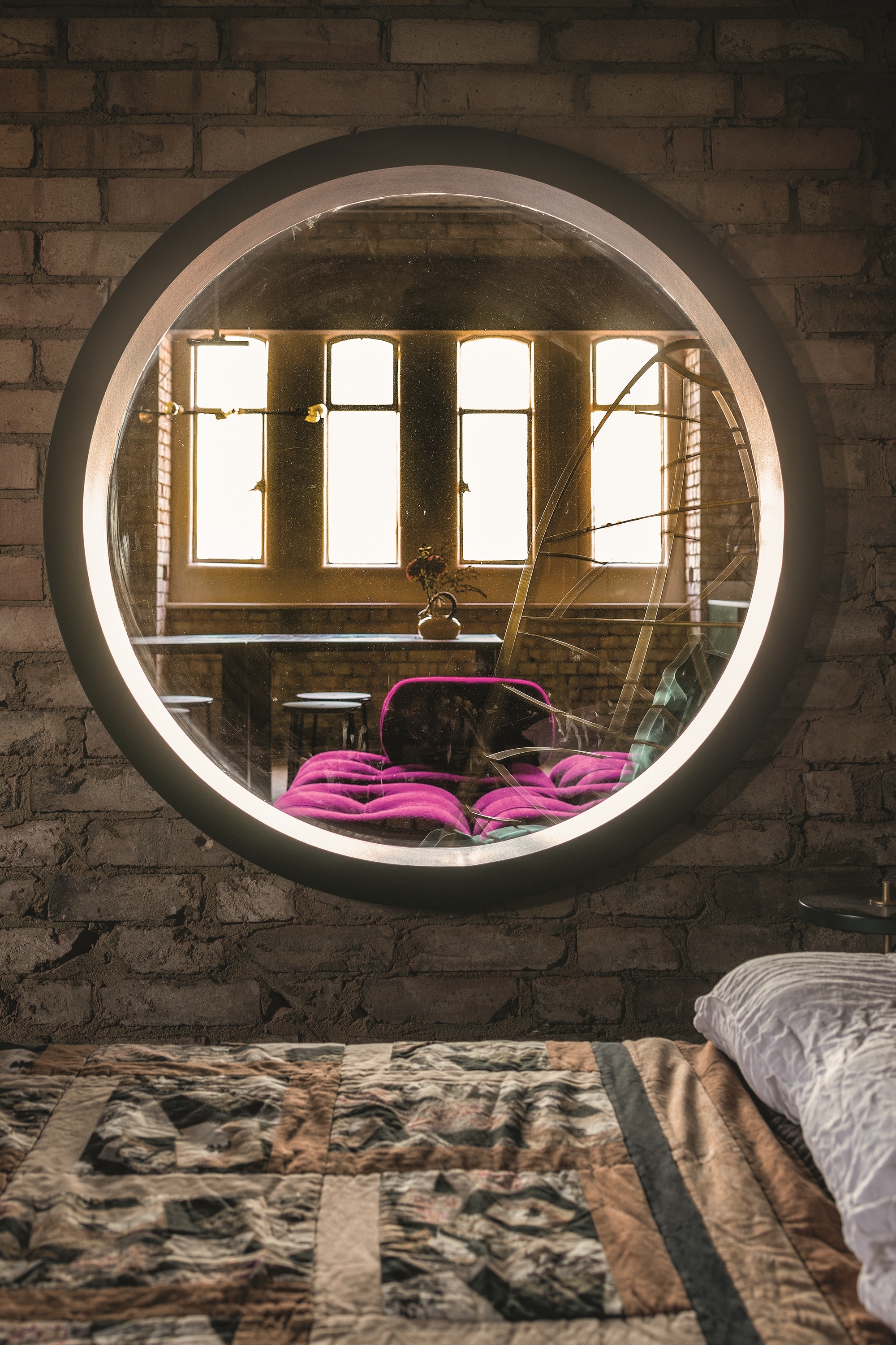 Bespoke shelving and steel hanging rails designed by Inter Urban Studios. Mirror, client&amp;rsquo;s own. Leather sofa, client&amp;rsquo;s own. Glass wall sconce by Illuminate Vintage from Etsy.