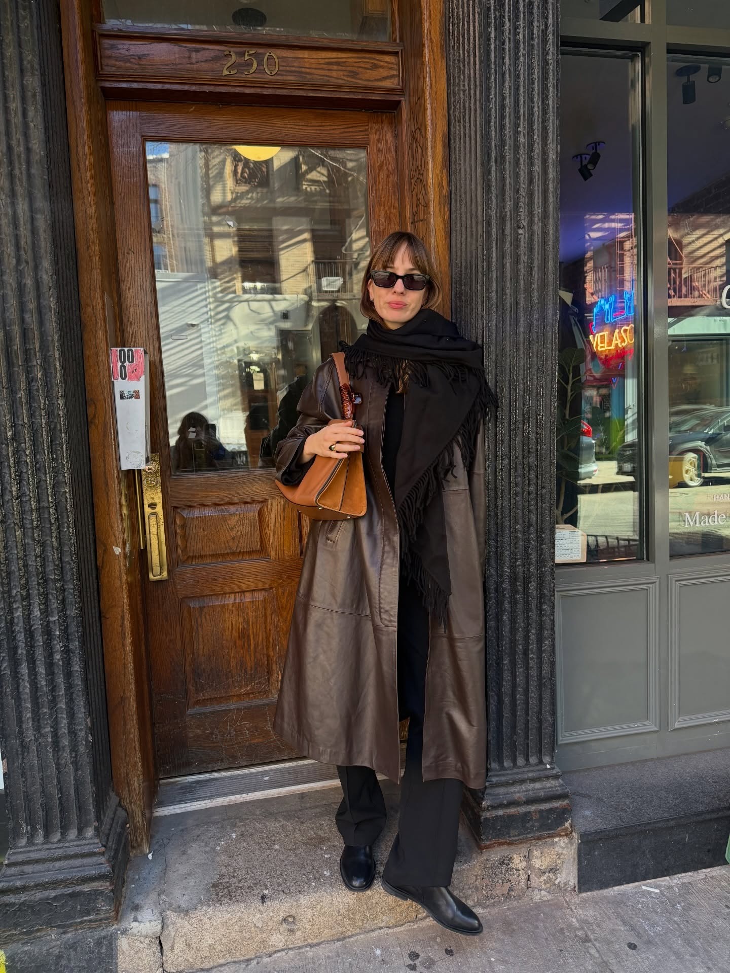 An influencer wearing a black trousers outfit.