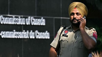 An Indian policeman stands guard outside the entrance of the Canadian High Commission in New Delhi 