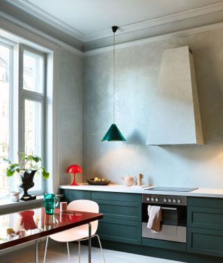 a kitchen with a limewash wall and extractor