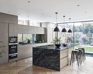 Kitchen layout ideas with large black marble island and modern cabinets