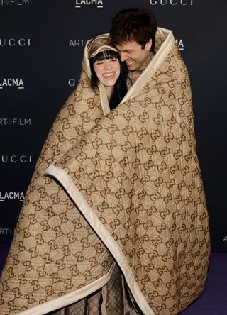 Billie Eilish and Jesse Rutherford on the red carpet in a Gucci blanket