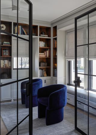 A living room with two navy blue accent chairs