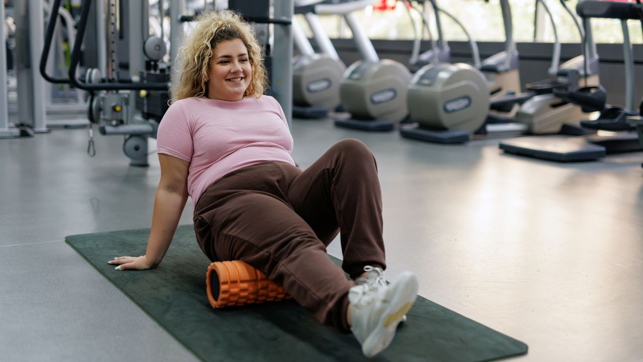 woman using foam roller in the gym