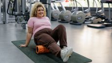 woman using foam roller in the gym