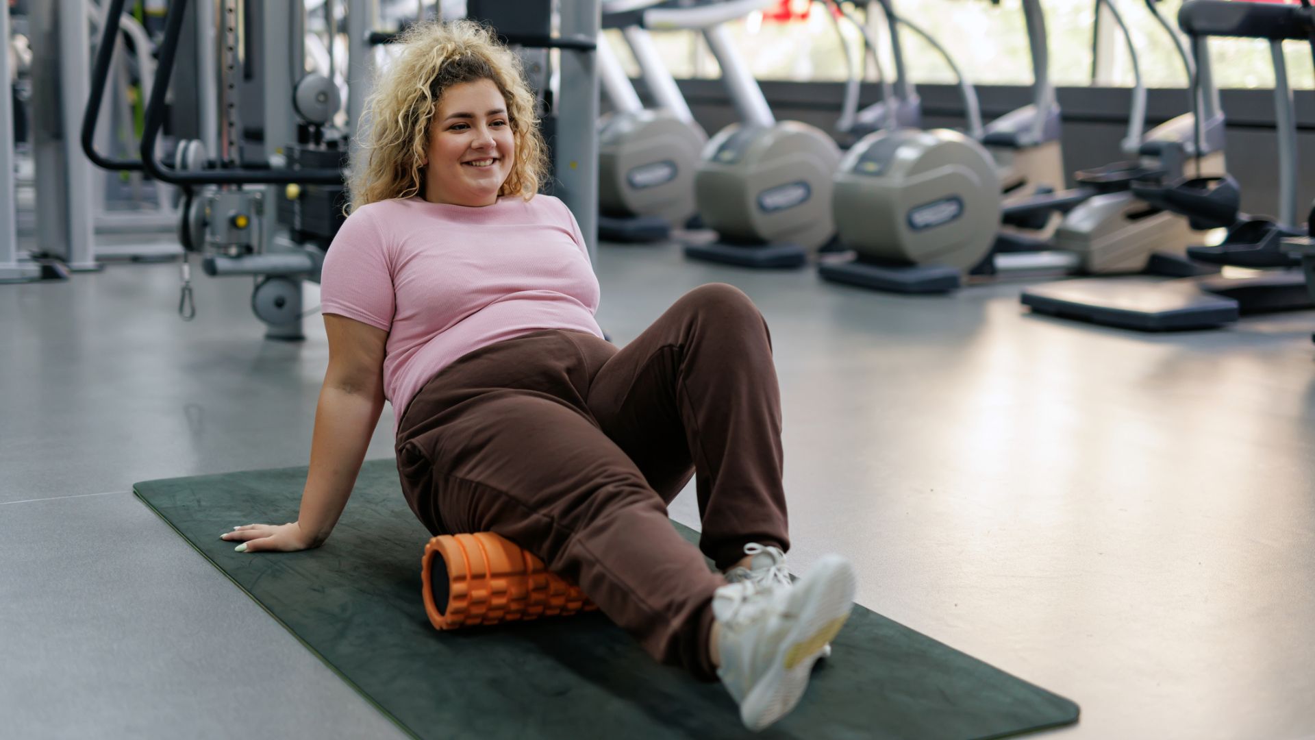 woman using foam roller in the gym