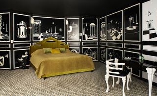 Mustard coloured bed with black and white designed walls