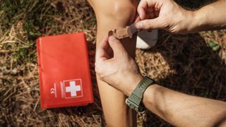 First aid kit in use with plasters