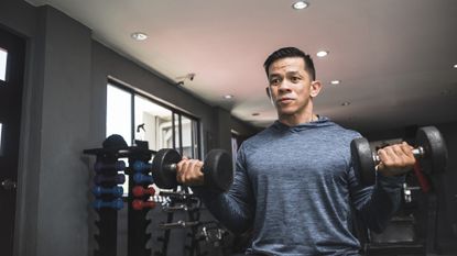 Man performing dumbbell bicep curls