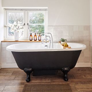 bathroom with bathtub and wall tiles