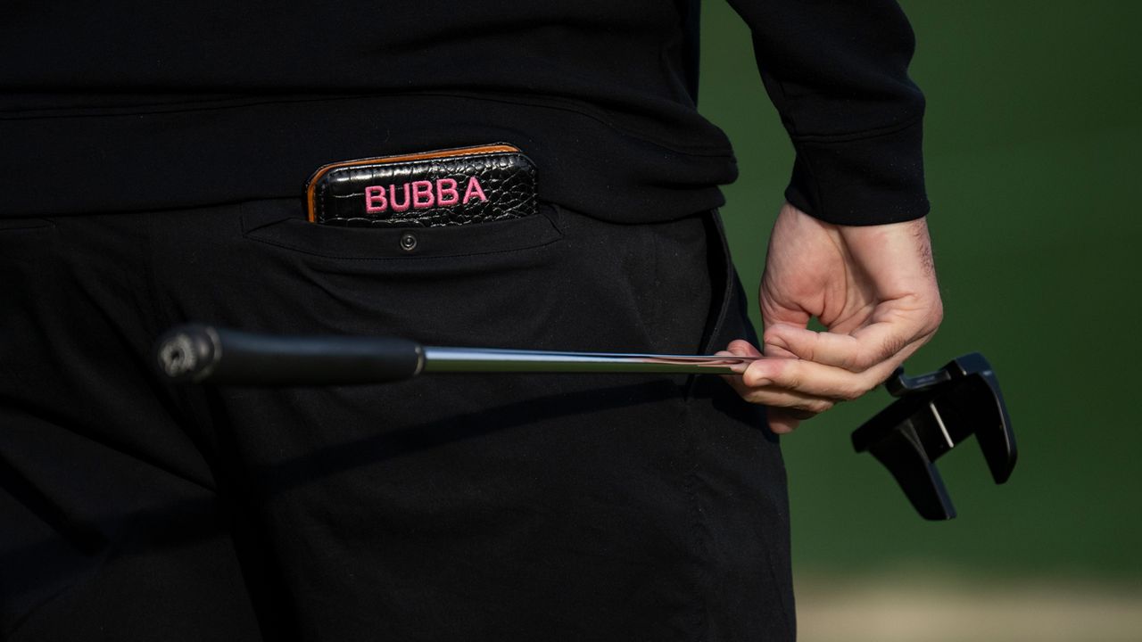 A close up Bubba Watson's putter and yardage book
