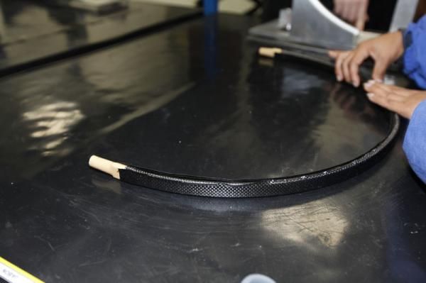 For the rim's internal cavity, pieces of carbon-HMPE are wrapped by hand around a mandrel that is later removed.