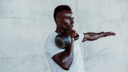 A man holding a kettlebell in the front rack position