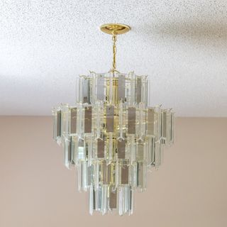 Glass light fixture on white popcorn ceiling
