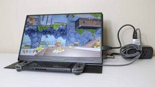 A Nintendo Switch plugged into a portable monitor using the Genki Covert Dock Mini