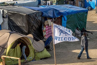 A Refugees Welcome flag in a French refugee camp.