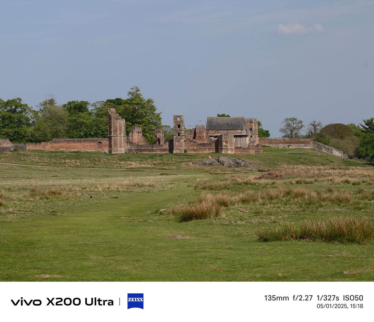 Old ruins in the distance across a field