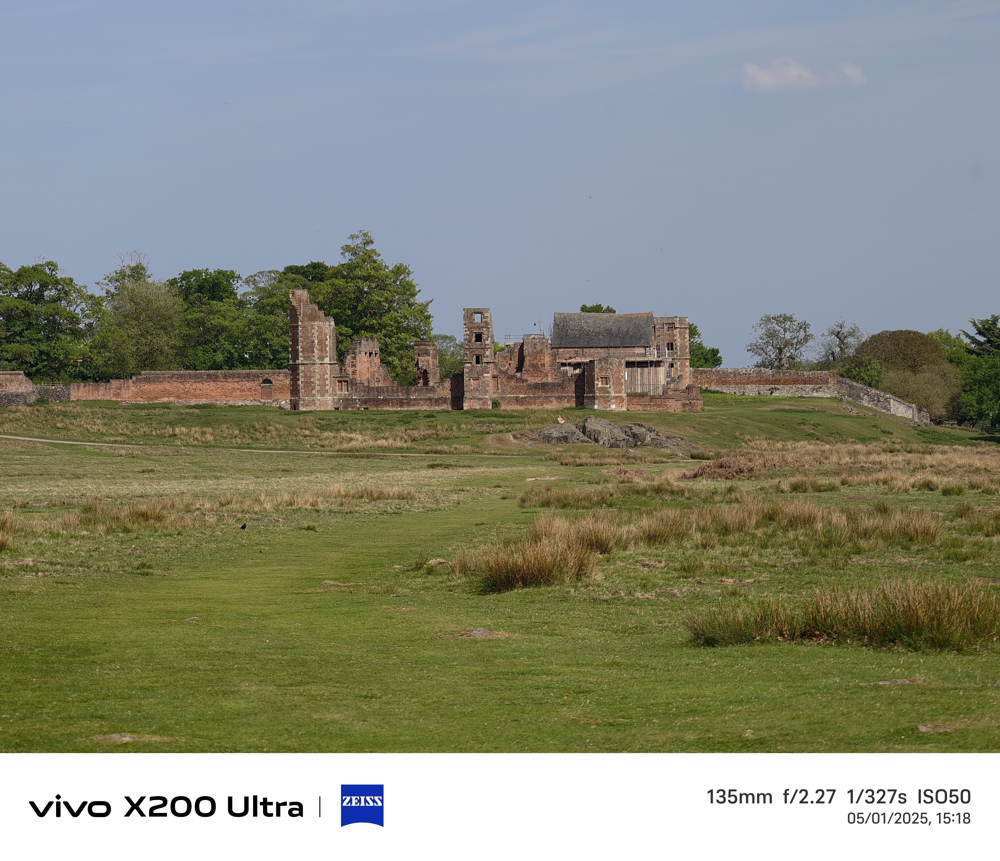 Old ruins in the distance across a field