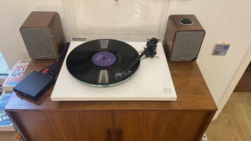 Rega Planar 3 turntable and Ruark MR1 speakers on wooden cabinet