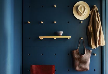 Hanging storage on an entryway pegboard