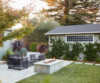 modern garden with statement furniture fire pit and patio