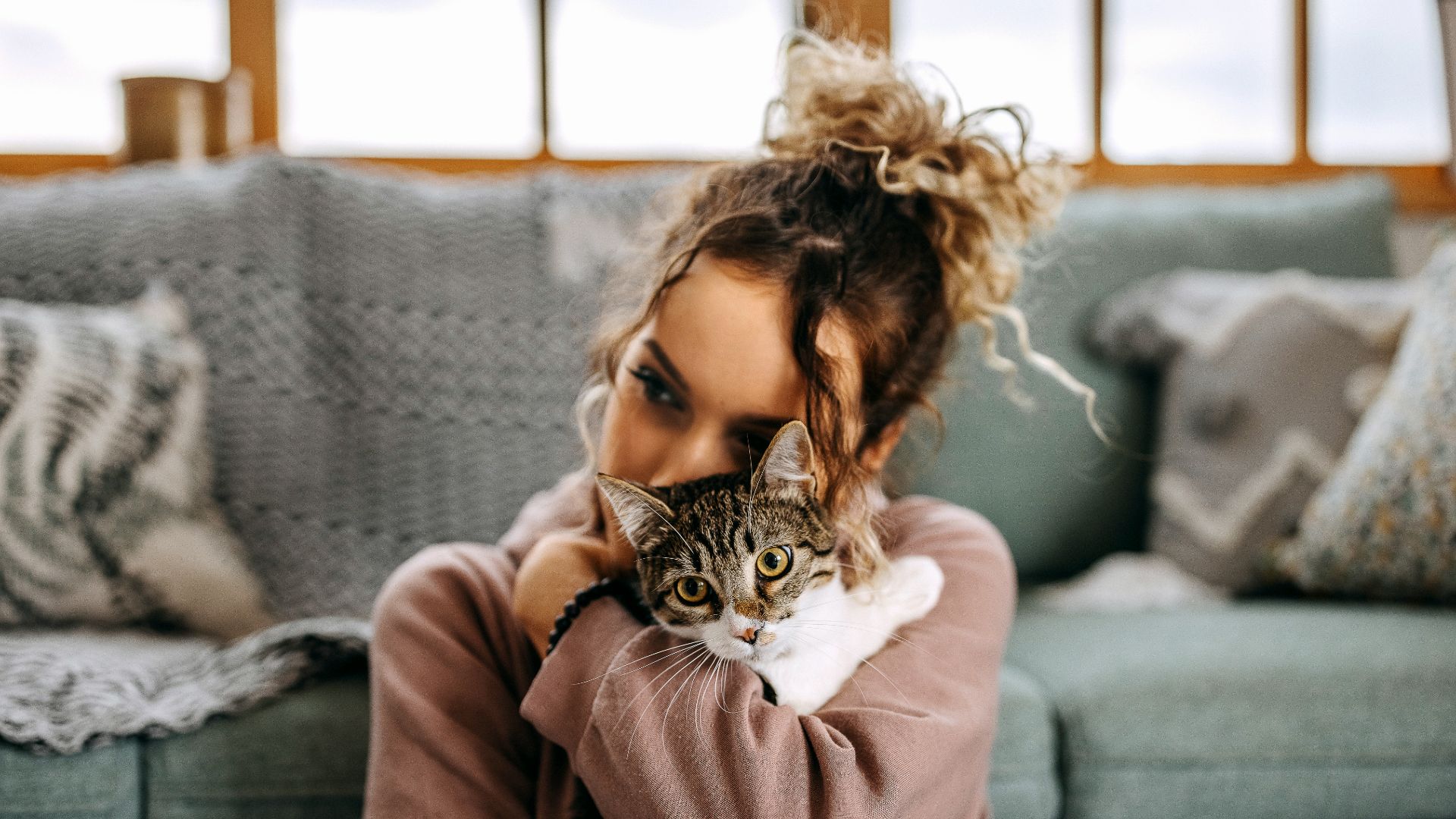 Woman snuggling cat