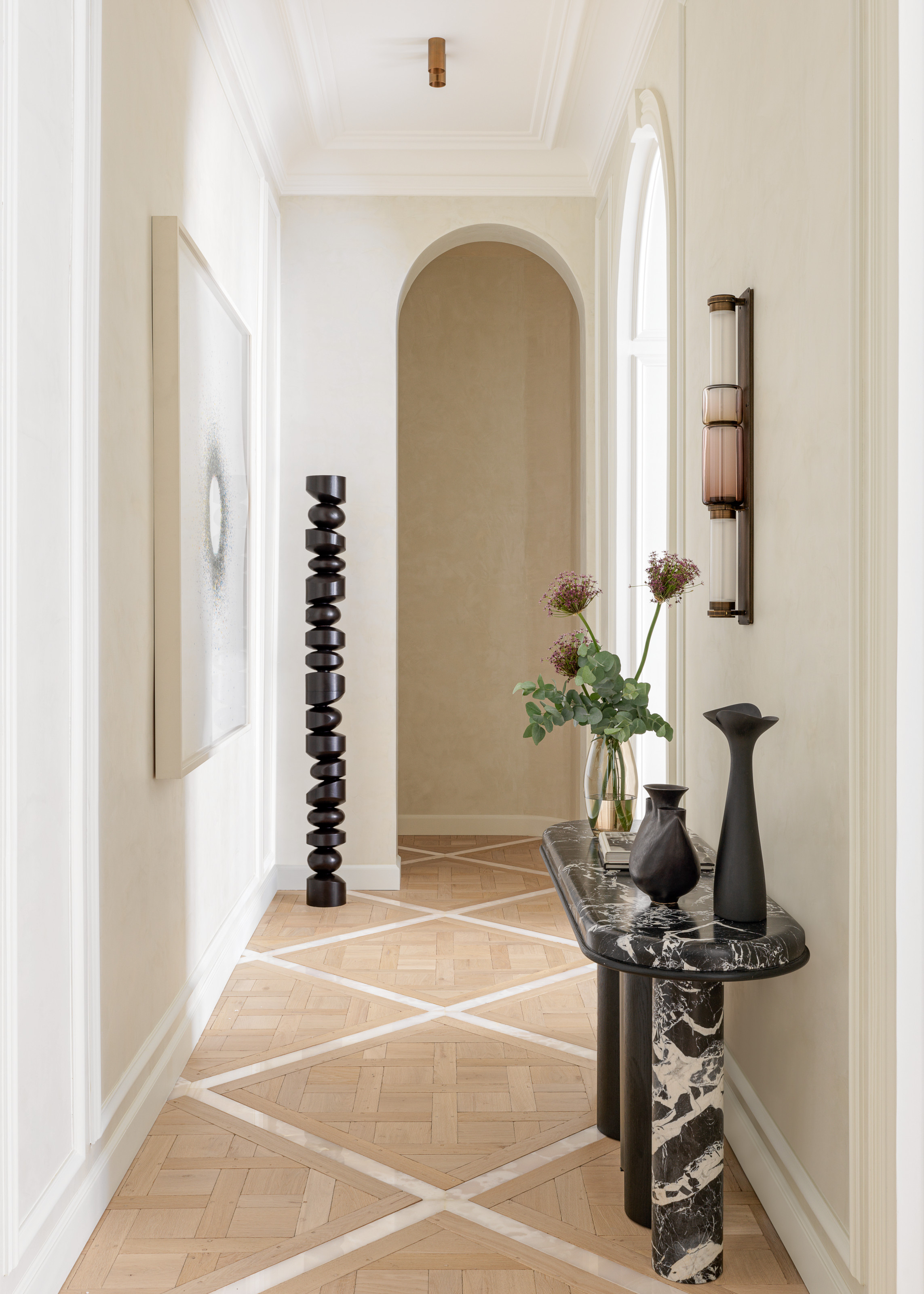 Cream hallway with black and white marble console