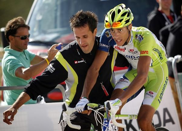 Eros Capecchi (Liquigas-Cannondale) is assisted by a soigneur after finishing 6th atop the Bola de Mundo.