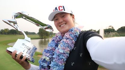 Angel Yin imitates a selfie as she poses with the Buick LPGA Shanghai Champion Trophy after winning at Shanghai Qizhong Garden Golf Club