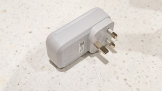 The Hive Active Smart Plug laying on its side on a countertop