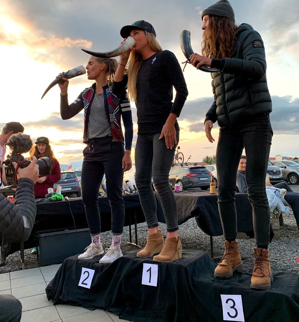 Alison Tetrick (centre) receives Viking horn on podium as 2019 winner of 200km elite women's The Rift