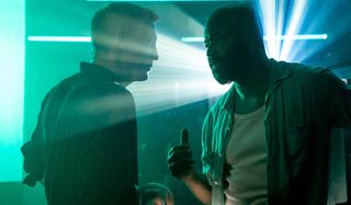 No Time To Die Daniel Craig and Jeffrey Wright talk in a brightly lit bar