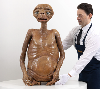 A sci-fi alien movie prop with an auction employee