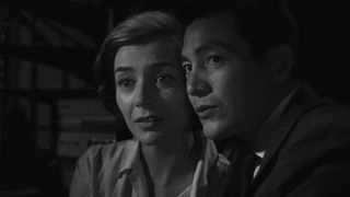 A French woman and Japanese man caress in Hiroshima mon amour