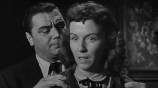 Ernest Borgnine rubbing Betsy Blair's shoulders in Marty